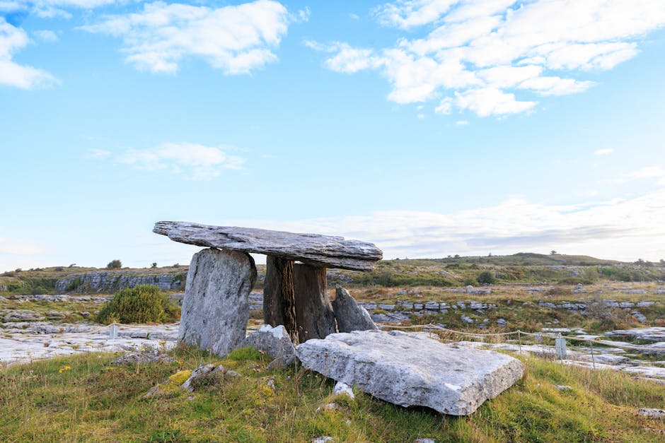 Rolling green hills of Ireland with ancient stone, ancestral homeland of the Celtic knotwork tradition