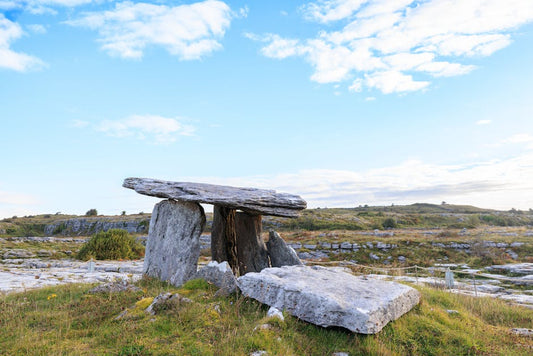 Rolling green hills of Ireland with ancient stone, ancestral homeland of the Celtic knotwork tradition