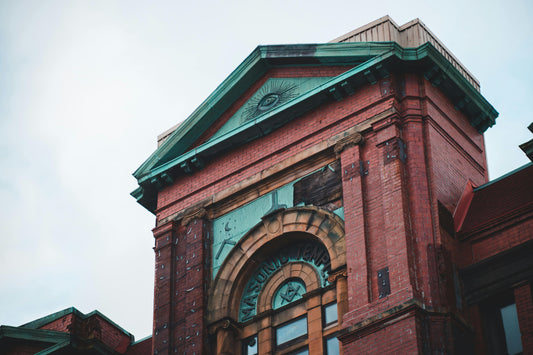 Low-angle view of ornate historic Masonic Temple facade with decorative brick masonry and classical architectural details