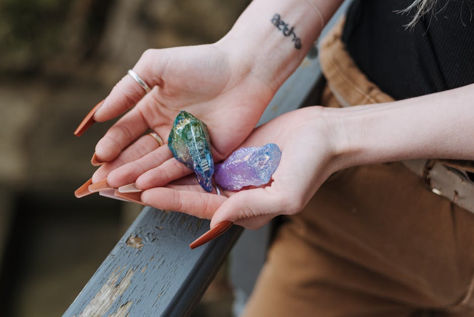Colorful uncut raw opal specimens displayed in cupped palms overhead view showing natural play-of-color