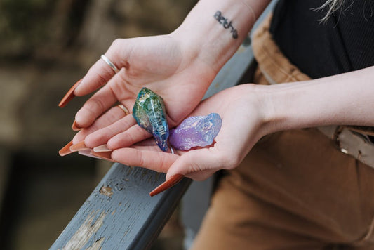 Colorful uncut raw opal specimens displayed in cupped palms overhead view showing natural play-of-color